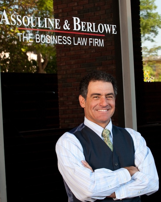 048 Eric in Front of Assouline   Berlowe Sign at Grove office (00150877)
